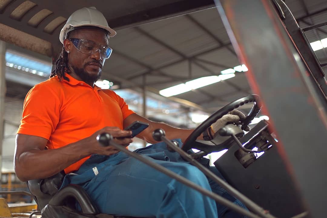 A factory worker operating a forklift